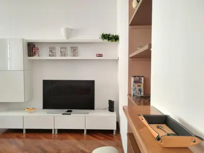 a living room with a television on a white cabinet at Dimora Roma Eterna, vacation & business in Rome