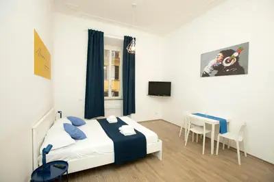 a bedroom with a bed and a desk in it at Manara10 Apart Blu1 in Rome