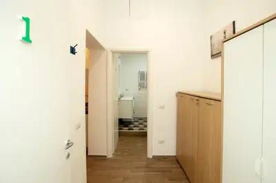 a hallway with a door to a bathroom with a sink at Manara10 Apart Blu1 in Rome