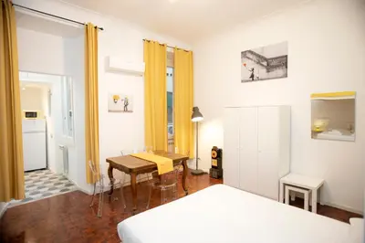 a bedroom with a bed and a table and a desk at Manara10 Apart giallo2 in Rome