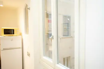 a window in a kitchen next to a refrigerator at Manara10 Apart giallo2 in Rome