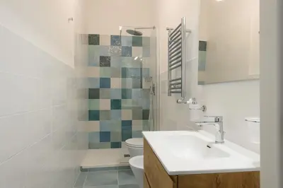 a bathroom with a sink and a toilet at Magnoliahome Suites at the Vatican in Rome