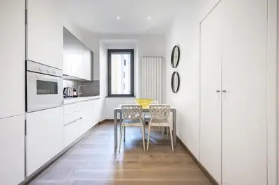 a kitchen with a table and two chairs at Casa Sistina in Rome