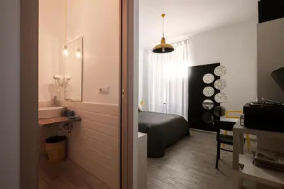 a bedroom with a bed and a bathroom with a sink at Room of Arts in Rome