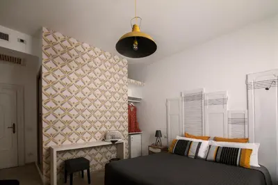 a bedroom with a bed and a wall at Room of Arts in Rome