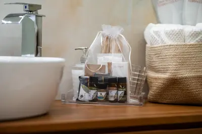 a bathroom counter with a bunch of products on it at Paci Luxury Suite in Rome