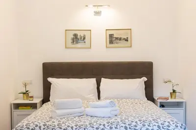 a bedroom with a bed with two pillows on it at Vatican Apartment 2 minuti da città del vaticano in Rome