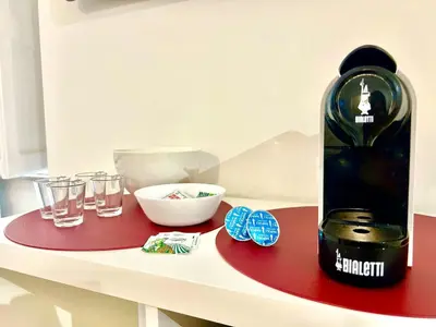 a table with a bottle of wine and glasses on it at Vatican Apartment 2 minuti da città del vaticano in Rome