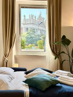 a bedroom with a window with a view of a building at Vacanze Romane Basilica in Rome