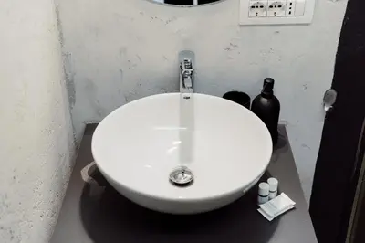 a bathroom with a white sink in a room at Monti Urban Studio by Valentina's Dream in Rome