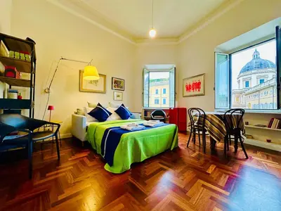 a bedroom with a bed and a table and chairs at Santa Maria Maggiore Suites Apartments in Rome