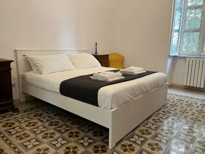 a bed with two towels on it in a bedroom at Gianicolo Hill Apartment in Rome