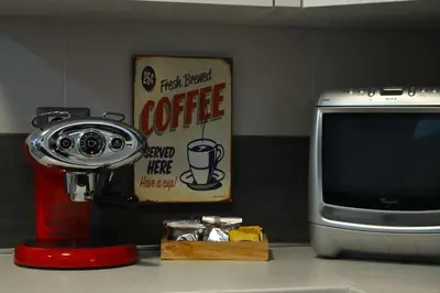 a table with a coffee machine and a tv at Casa Cycas in Rome