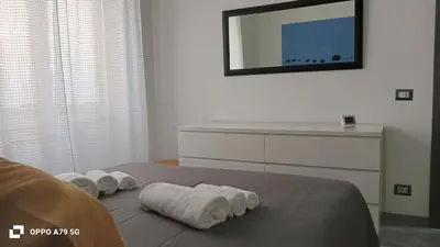 a bedroom with two rolled towels on a bed at Casa Cycas in Rome