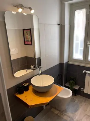 a bathroom with a sink and a mirror at Casa Cycas in Rome