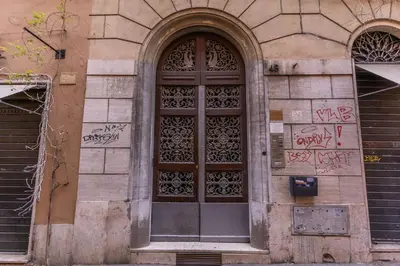 a door with graffiti on the side of a building at Residenza Ripetta in Rome
