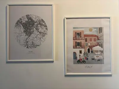 two framed pictures hanging on a wall at Aulo Plauzio Apartment in Rome