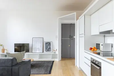 a living room with a couch and a kitchen at iFlat Contemporary Elegant Skyline in Rome in Rome