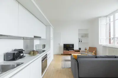 a kitchen and living room with a couch and a table at iFlat Bright & Modern Living with Panoramic View in Rome