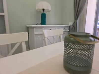 a table with a green trash can on top of it at San Paolo Charme Apartment in Rome