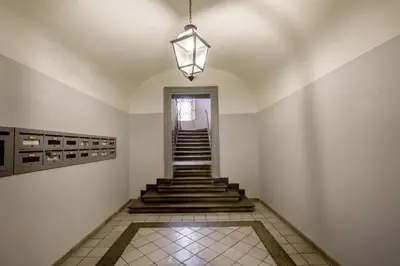 a hallway with stairs and a chandelier in a building at BeSecret Belsiana in Rome