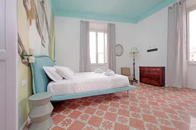 a bedroom with a bed and a dresser in it at Modern retreat with Spectacular St Peter's views in Rome