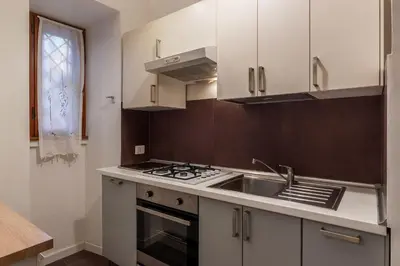a kitchen with a sink and a stove top oven at GuestHost Cozy Flat X4 - 450m to Vatican City! in Rome