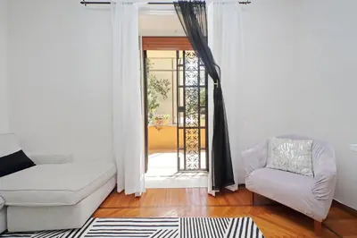 a living room with a couch and a chair and a door at 4BNB - Annibaliano Metro Apartment in Rome