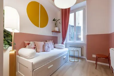 a small bedroom with a white bed with a window at The 38 Home Exclusive - Homkeey Apartments in Rome