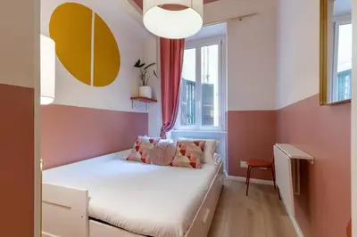 a small room with a bed and a window at The 38 Home Exclusive - Homkeey Apartments in Rome