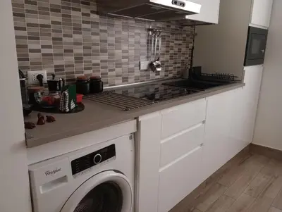 a kitchen with a washing machine in a kitchen at Dimora Vaticano Rome Apartments in Rome
