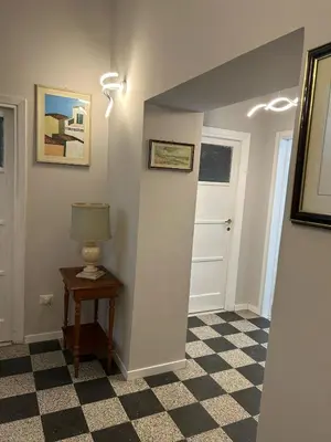 a hallway with a lamp on a table and a door at GiusPa casa in Rome
