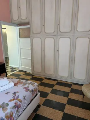 a bedroom with a bed and a checkered floor at GiusPa casa in Rome