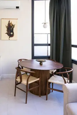 a wooden table and chairs in a room with a window at La Terrazza di Ermini in Rome