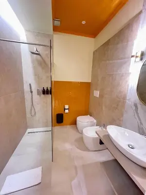 a bathroom with a shower and a toilet and a sink at Mia House Prestige in Rome