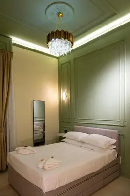 a bedroom with a large bed with a chandelier at Mia House Prestige in Rome