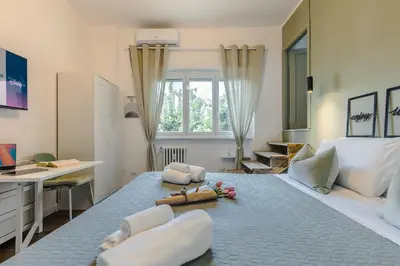 a bedroom with a large bed with a desk at Oasis house Trastevere in Rome