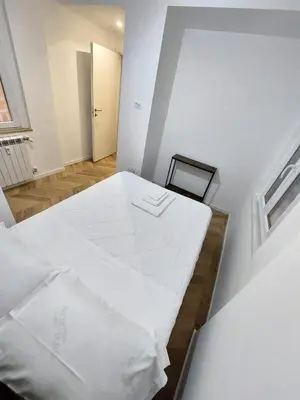 a white room with a bed and a window at Alessi Home Pigneto in Rome