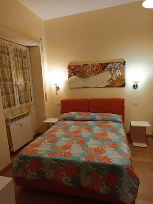 a bedroom with a bed and a painting on the wall at Alloggio turistico Artù in Rome