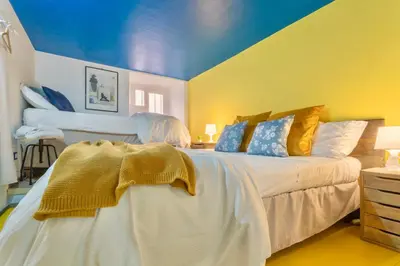 a bedroom with a large bed with a blue ceiling at Rossana Urban Style Loft close to Termini Station in Rome