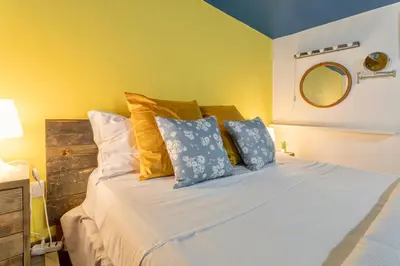 a bedroom with a bed with blue and yellow walls at Rossana Urban Style Loft close to Termini Station in Rome