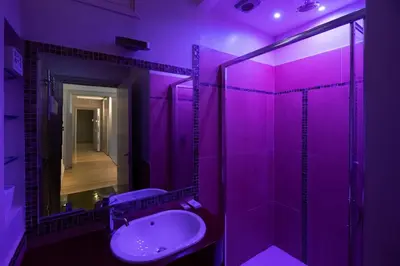 a purple bathroom with a sink and a mirror at Villa Ada Apartment - Parioli in Rome
