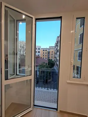 a room with a sliding glass door with a balcony at MariElu a Trastevere in Rome