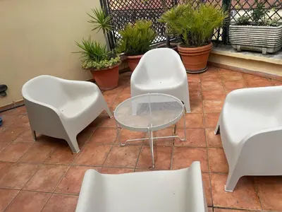 two white chairs and a table and some plants at La Dolce Vista in Rome