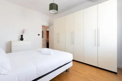a white bedroom with a bed and white cabinets at Agostini 9- Bright Flat in Rome