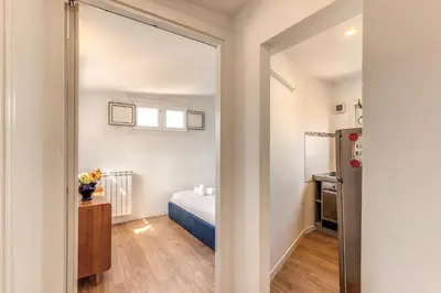 a small bedroom with a bed and a mirror at Attic with terrace Spanish Steps exclusive in Rome
