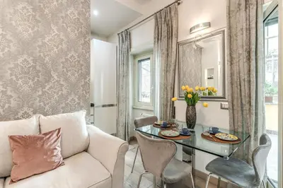 a living room with a table and a couch at Santa Croce apartment with private terrace in Rome