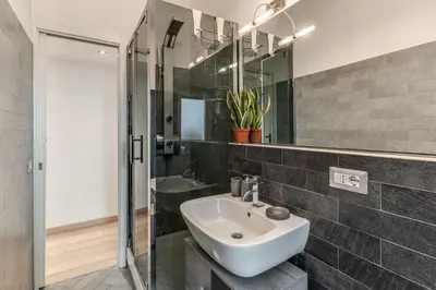 a bathroom with a white sink and a mirror at Santa Croce apartment with private terrace in Rome