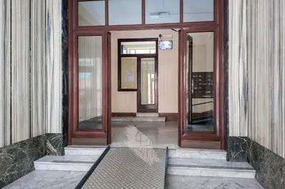 an entrance to a building with two wooden doors at Prestige Bellavista Apartment in Rome