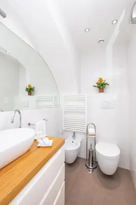 a white bathroom with a sink and a toilet at Casa Di Armando al Pantheon in Rome